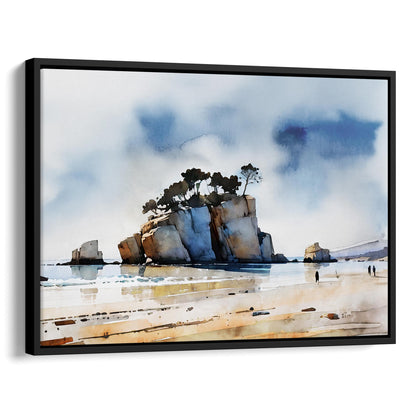 Black framed canvas watercolor print of a coastal scene with a large rock formation topped with windswept trees, calm water reflections, and a sandy shore with a few distant figures.
