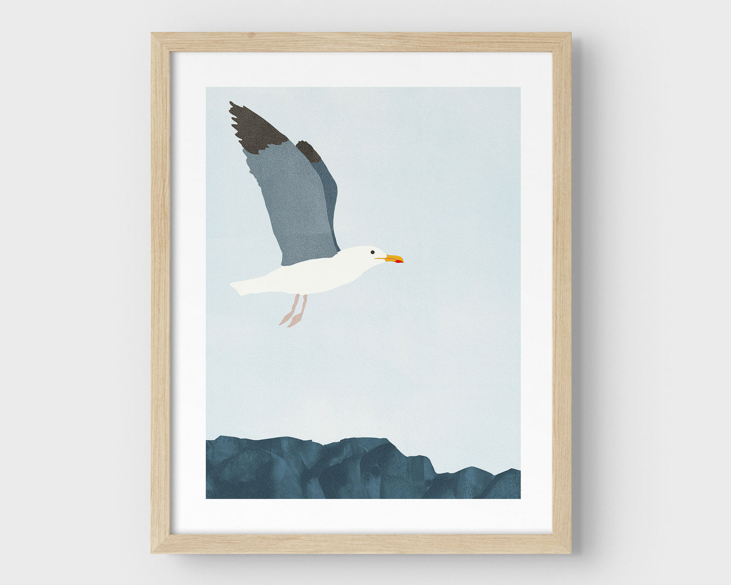Minimalist digital illustration of a seagull in mid-flight with wings partially raised, soaring above a rocky surface against a pale blue sky, framed in natural wood.