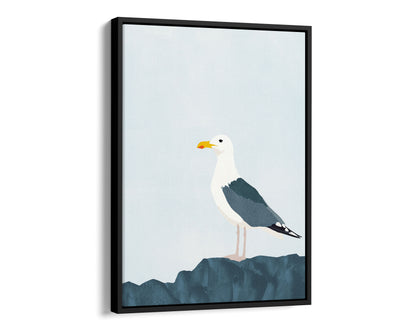 Black framed canvas print of a minimalist illustration of a seagull standing on a dark blue rock against a pale blue background.