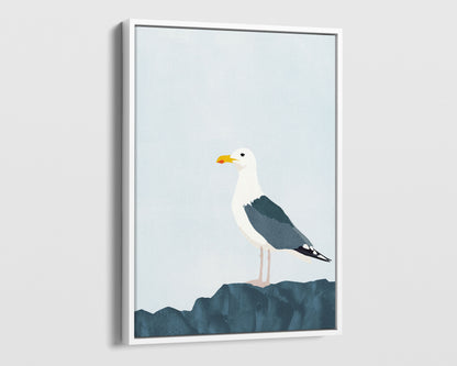 White framed canvas print of a minimalist illustration of a seagull standing on a dark blue rock against a pale blue background.
