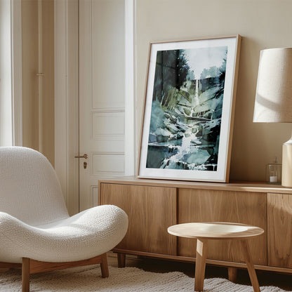 Framed watercolor painting of a cascading waterfall, placed on a wooden sideboard in a cozy, neutral-toned room with a modern chair.