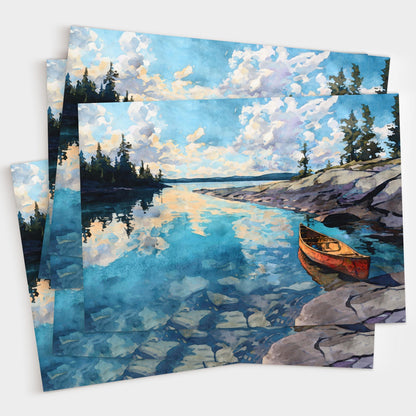 Set of greeting cards featuring a watercolor painting of a red canoe on rocky shore beside a calm blue lake. The water reflects clouds and pine trees along the horizon, creating a peaceful wilderness landscape. Cards are shown stacked with artwork visible.