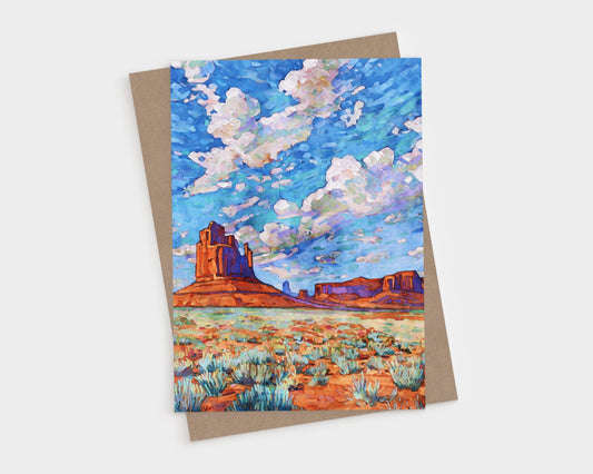 Monument Valley desert landscape with red rock buttes, blue sky, and colorful wildflowers, printed on a vertical folded greeting card.